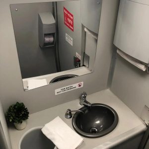 Interior of 2-stall VIP restroom trailer with sink and mirror for events in Rancho Cordova, CA