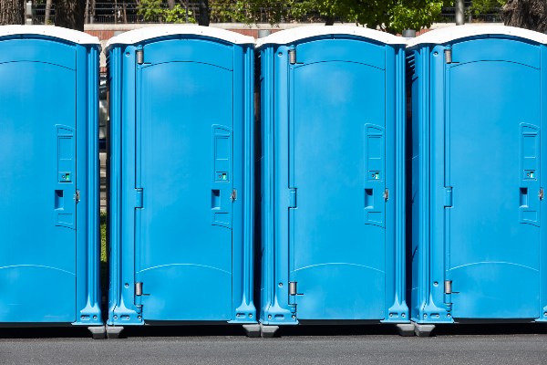 Portable toilets arranged in a parking lot, designated for event use in Rancho Cordova, CA