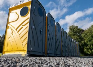 A row of portable toilets under a clear blue sky in Rancho Cordova, CA, set up for events