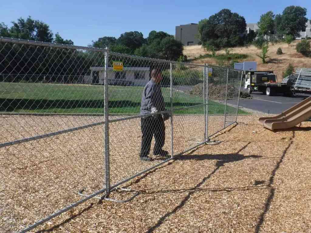 Temporary panel fencing displayed at a playground in Rancho Cordova, CA